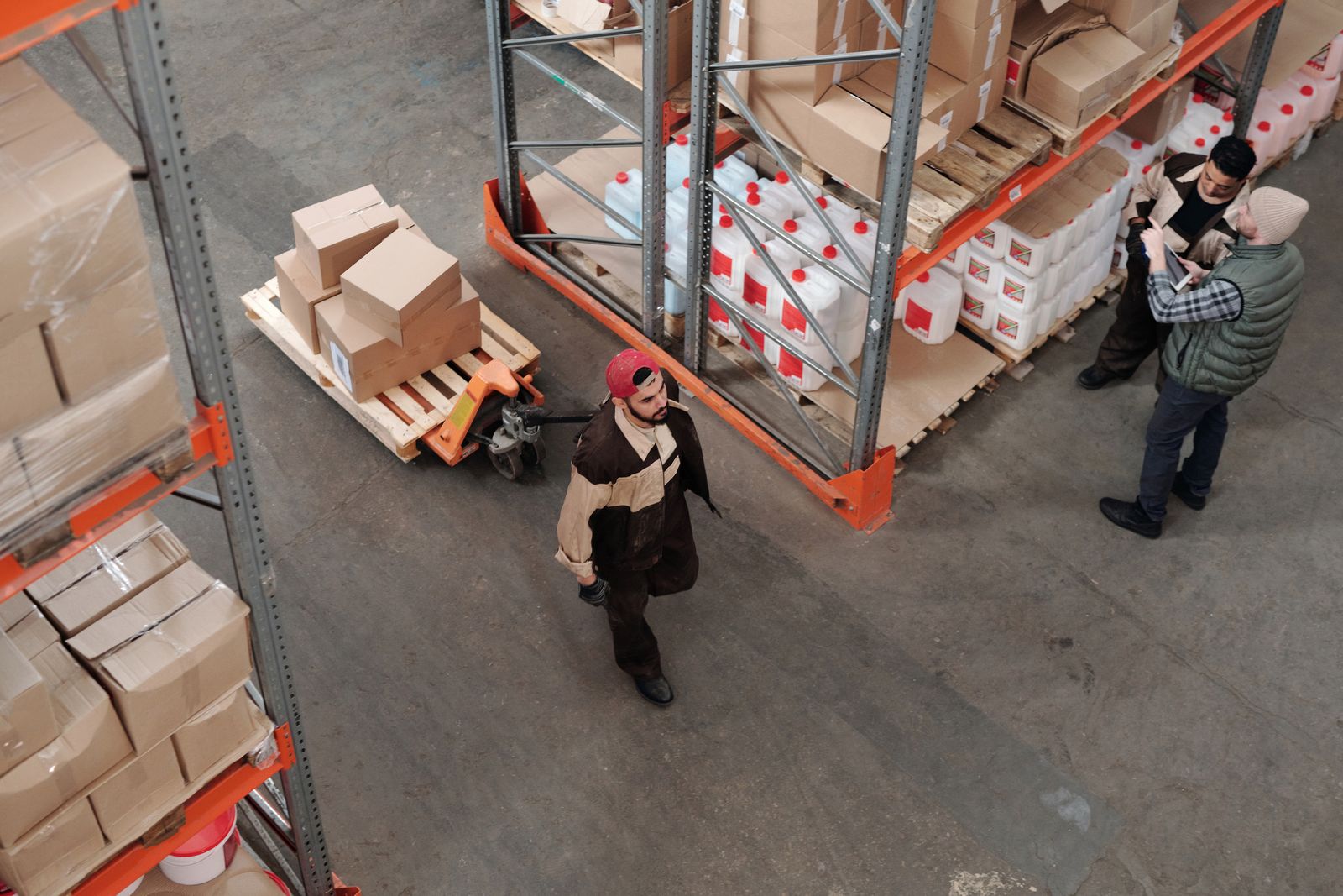 Warehouse staff discussing inventory and shipment operations.